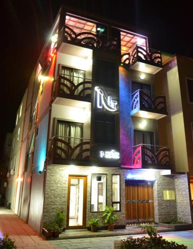 a building with a sign on it at night at Newtown Inn in Hulhumale