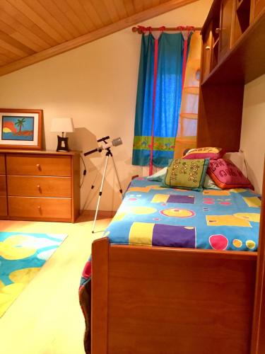 a bedroom with a bed and a dresser at Casa da Quinta in Oliveira do Hospital