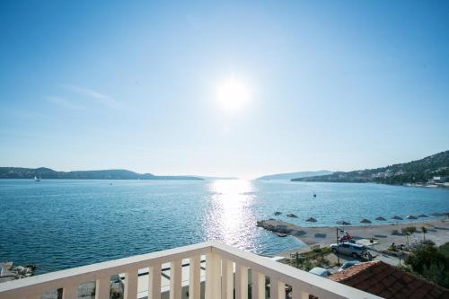 a view of a body of water from a balcony at Kaja - right next to the beach in Trogir