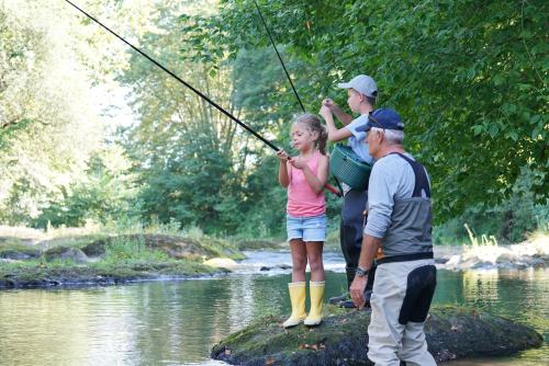 a man and a girl fishing in a river at Tingsryd Resort in Tingsryd
