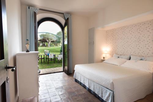 a bedroom with a bed and an open door at Villa Coralia Country House in Osimo