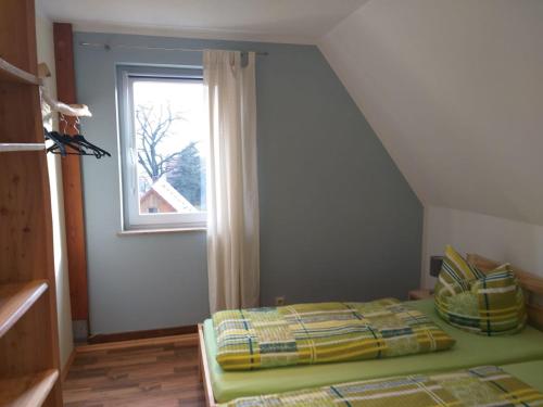 a bedroom with a bed in front of a window at Ferienappartment Henke in Hohnstein