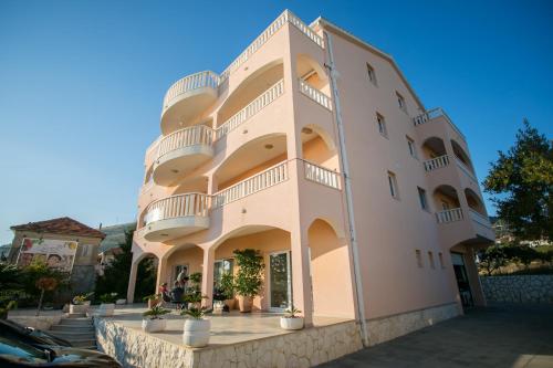 a large building with balconies on the side of it at Kaja - right next to the beach in Trogir