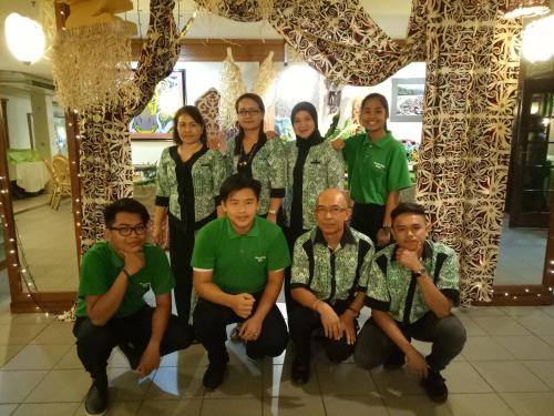 a group of people posing for a picture in a building at Telang Usan Hotel Kuching in Kuching