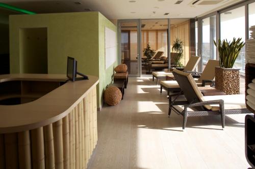 an office lobby with chairs and a reception desk at Hotel Ponteo - Activity Park in Bratislava