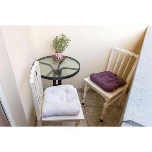 a table and two chairs and a glass table and chairs at Kata's Place in Subotica