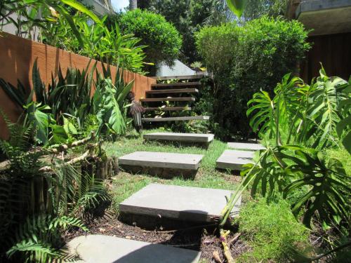 a garden with steps with plants and a fence at Mercatto Casa Hotel Boutique in Arraial d'Ajuda