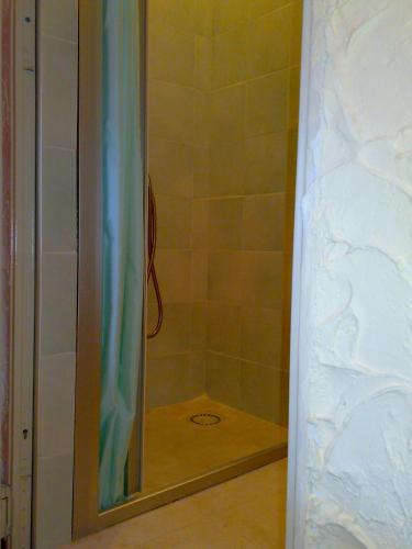 a shower with a glass door in a bathroom at Ianua Coeli 2 in Mosso Santa Maria