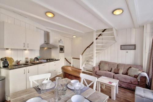 a kitchen and living room with a couch and a table at Jordaan Apartment 6 in Amsterdam