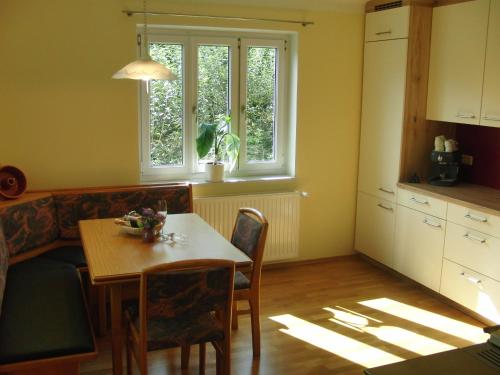 a kitchen and dining room with a table and a couch at Ferienhaus Grabenhansl in Stubenberg