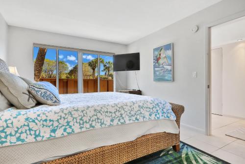 a bedroom with a bed and a large window at Whitney Beach View 332 in Longboat Key