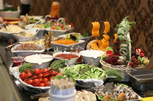 a buffet of vegetables and other foods on a table at Khazri in Baku