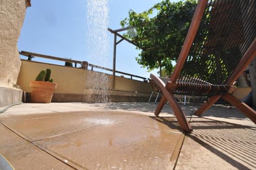 a wooden rocking chair sitting on a patio at Casa Lucas in Ager