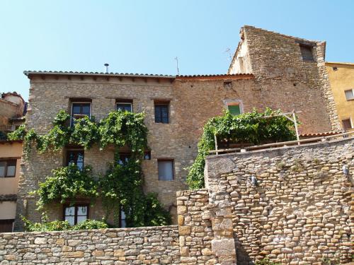 an old brick building behind a stone wall at Casa Lucas in Ager