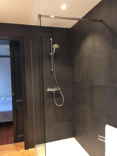 a shower with a glass door in a bathroom at Ter Thuyne in Ieper