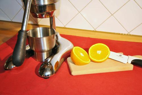 a cutting board with an orange cut in half on a counter at Villa Stefania in Noventa Padovana