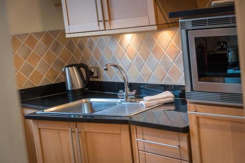 a kitchen with a sink and a microwave at 3c Dublin Street in Edinburgh