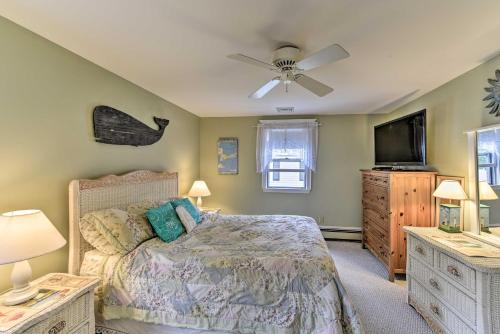 a bedroom with a bed and a ceiling fan at Charming East Falmouth Home Walk to Private Beach in East Falmouth