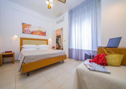 A bed or beds in a room at Mediterraneo Hotel & Suites