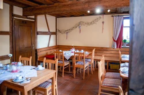 een eetkamer met houten tafels en stoelen bij Hotel Schuberths am Markt in Buttenheim