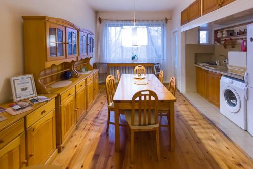 cocina con mesa de madera, sillas y fregadero en Maritza Apartment, en Plovdiv