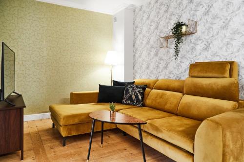 a living room with a couch and a table at Prime Location Apartment in Krakow