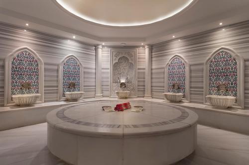 a large room with a round table and stained glass windows at Merit Crystal Cove Hotel Casino & SPA in Kérynia