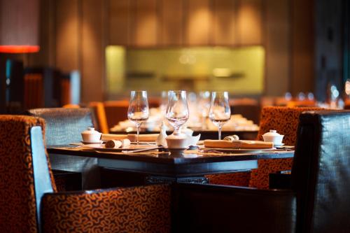 a table in a restaurant with wine glasses on it at Taj Palace, New Delhi in New Delhi