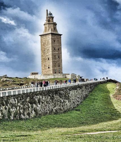 a lighthouse on top of a wall with a crowd of people at Hotel Almirante in A Coruña
