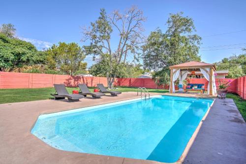 a swimming pool with chairs and a gazebo at Vintage Las Vegas Oasis Less Than 3 Mi to the Strip! in Las Vegas