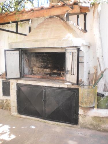 a building with a black garage door with ajar at Zavrakli in Agia Paraskevi