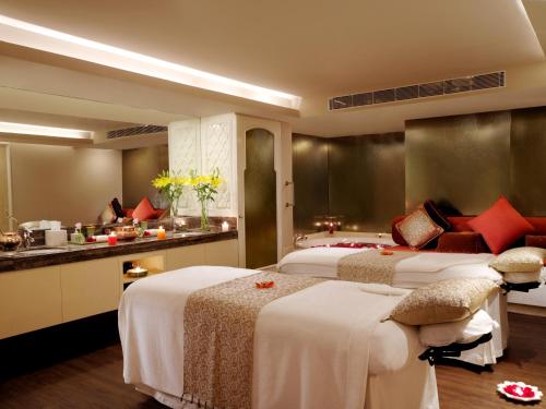 a hotel room with two beds and a kitchen at Taj Palace, New Delhi in New Delhi