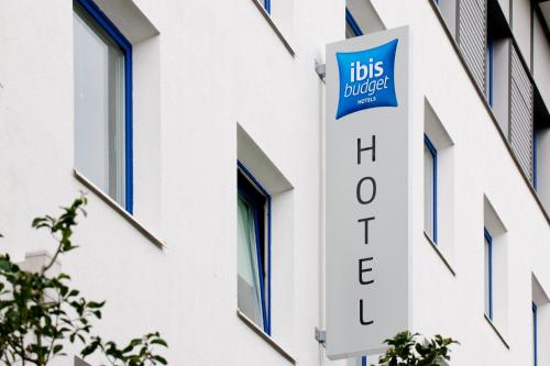 a sign on the side of a building with ahs united sign at ibis budget Stuttgart City Nord in Stuttgart