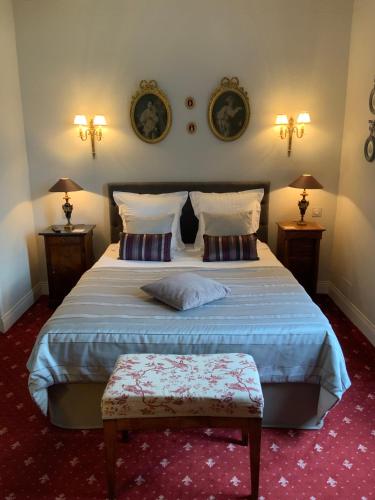 a bedroom with a large bed and two night stands at Victoria Arromanches B&B in Tracy-sur-Mer