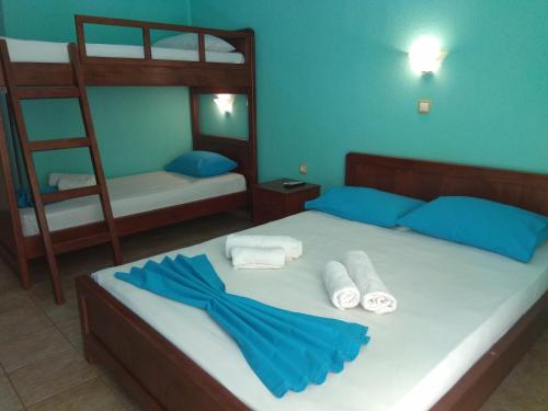 a bedroom with a bed with two bunk beds and towels at Villa Athina Gia in Sarti