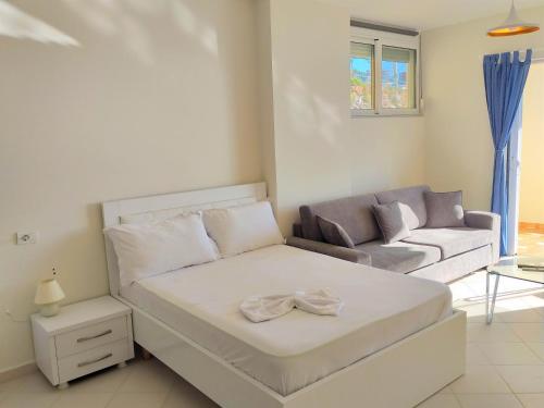a living room with a bed and a couch at Sail Ocean View Apartments in Sarandë