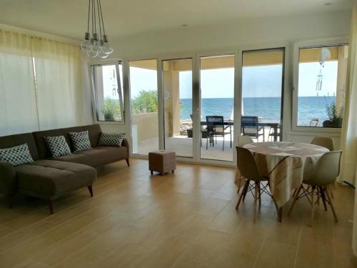 a living room with a couch and a table at Villa Dimitri - Beach House in Alexandroupoli