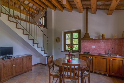 a kitchen with a dining room table and a staircase at Rustico del Conero in Camerano