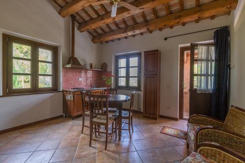 a kitchen with a table and chairs in a room at Rustico del Conero in Camerano