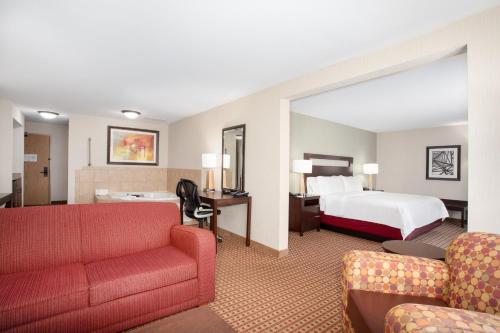 a large hotel room with a bed and a couch at Holiday Inn Express Hotel & Suites Gillette, an IHG Hotel in Gillette