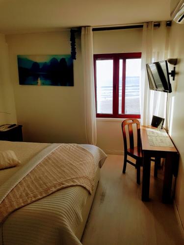a bedroom with a bed and a desk with a computer at Porto Sea Apartments in Matosinhos