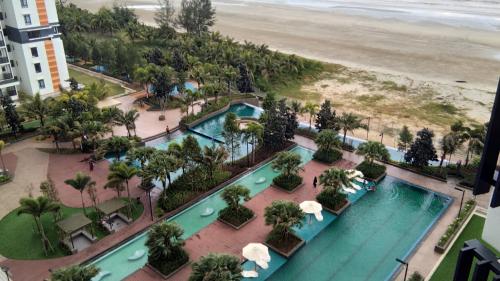 an aerial view of a resort with a pool and the beach at D'Qaseh Ummi Timurbay Pantai Balok Kuantan in Kuantan