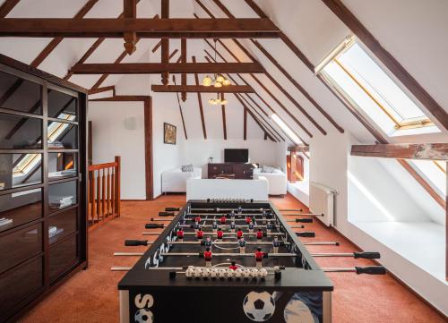 a room with a foosball table in a attic at Pensiunea Morii in Cristian
