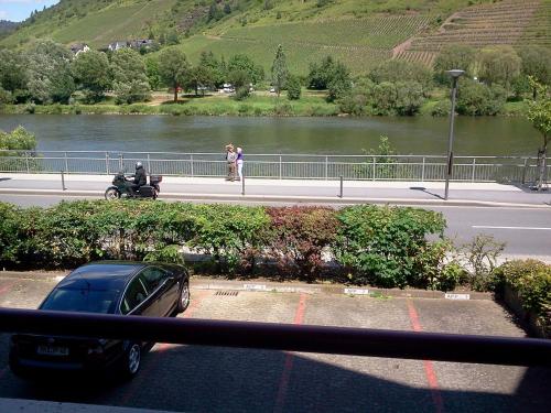 a car parked on a street next to a river at Appartement Moselblick in Cochem