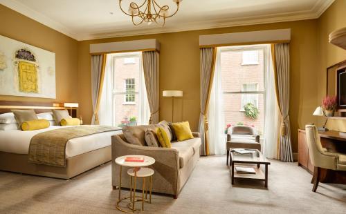 a hotel room with a bed and a couch at Trinity Townhouse Hotel in Dublin