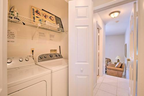 a laundry room with a washer and dryer at Canalfront Home with Private Saltwater Pool and Dock! in Marco Island