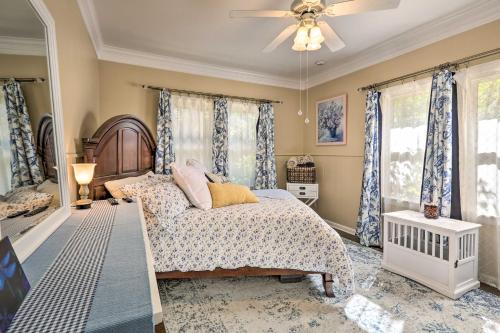 a bedroom with a bed and a ceiling fan at Ornate Cottage with Sunroom - Near MSU and Water Park! in Wichita Falls