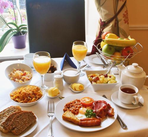 a table topped with plates of breakfast foods and drinks at Baggot Court Townhouse in Dublin