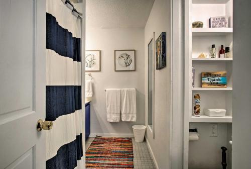 a small bathroom with a blue and white shower at Scenic Ludington Home about 1 Mile to Lake Michigan in Ludington