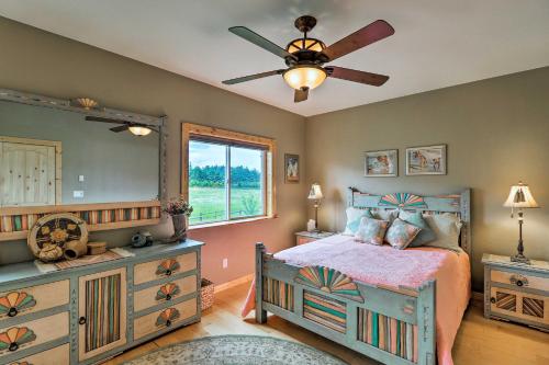 a bedroom with a bed and a ceiling fan at Cabin with Porch and View about 19 Mi to West Glacier in Columbia Falls